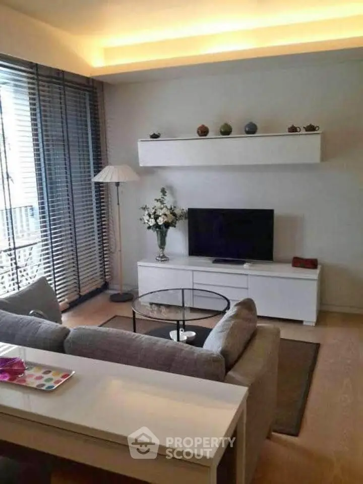 Modern living room with sleek furniture and ambient lighting, perfect for relaxation and entertainment.