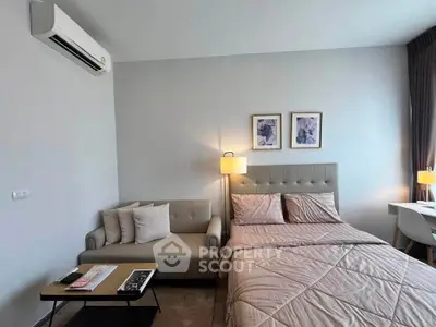 Modern bedroom with cozy sofa and stylish decor in a contemporary apartment.