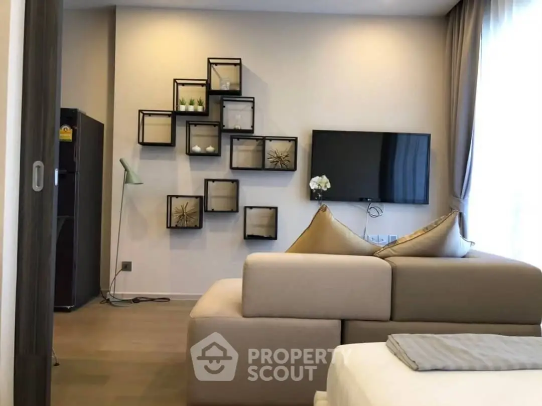 Modern living room with stylish wall decor and cozy sofa in a bright apartment.