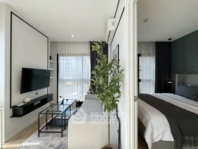 Modern living room with sleek design and natural light, adjacent to a cozy bedroom.