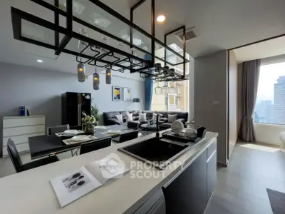 Modern open-layout kitchen and living room with city view, stylish decor, and ample natural light.