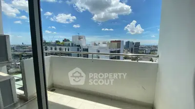 Stunning city view from modern high-rise balcony with clear skies