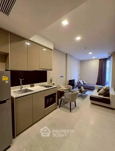 Modern open-plan kitchen and living area with sleek design and cozy ambiance.