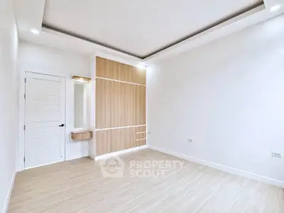 Spacious modern bedroom with wooden accents and sleek design