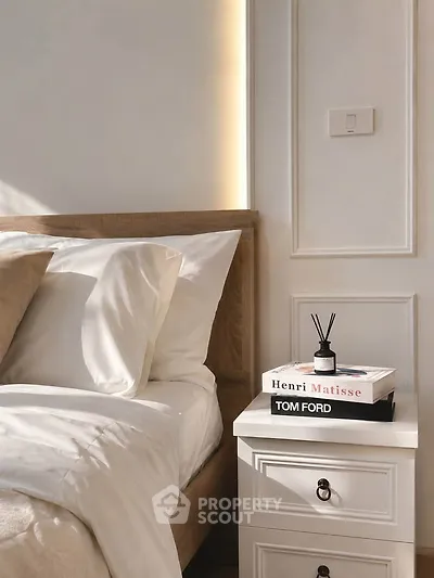 Elegant bedroom with stylish decor and natural light, featuring a cozy bed and chic nightstand.
