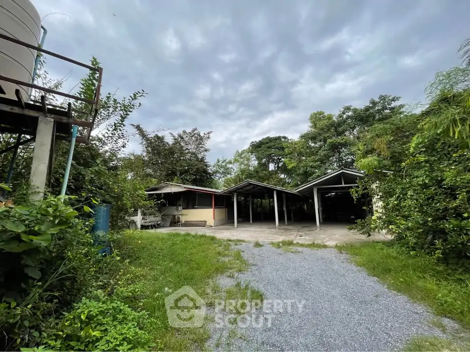 Charming rural property with lush greenery and spacious outdoor area, perfect for serene living.