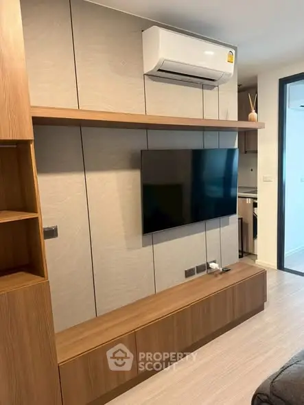 Modern living room with sleek wooden TV unit and wall-mounted air conditioner, perfect for stylish urban living.