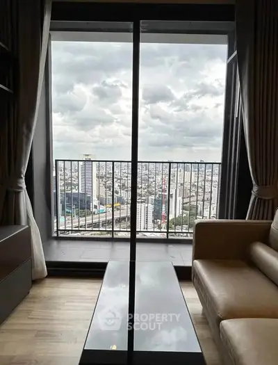 Stunning city view from modern apartment balcony with cozy living room setup.