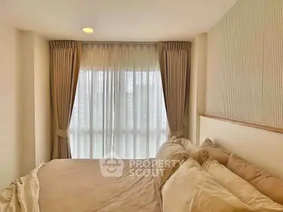 Cozy bedroom with elegant curtains and soft lighting, perfect for relaxation and comfort.