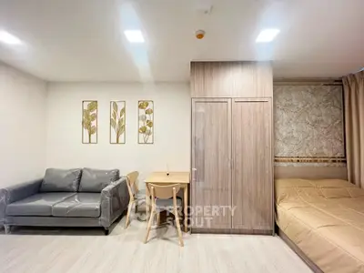 Modern studio apartment with cozy living area and stylish decor