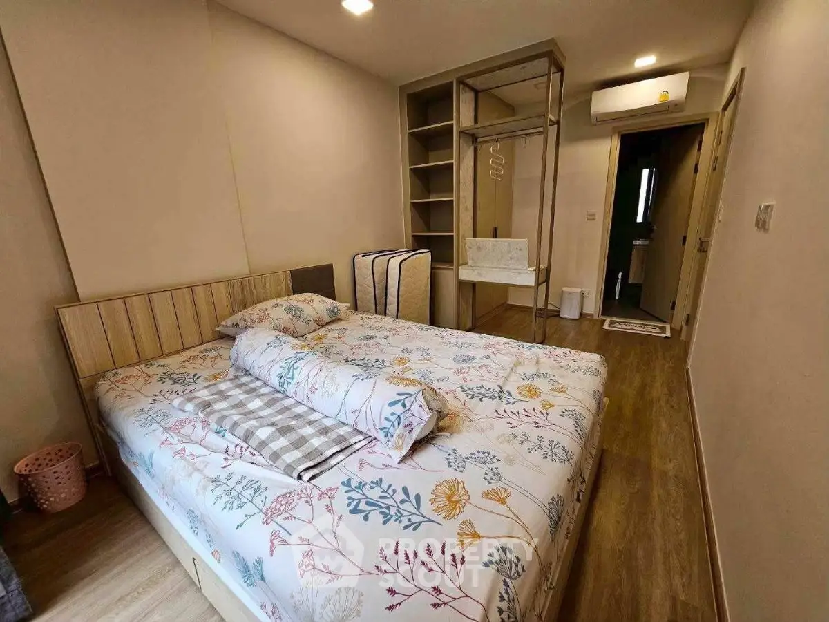Cozy bedroom with floral bedding and modern storage solutions in a stylish apartment.