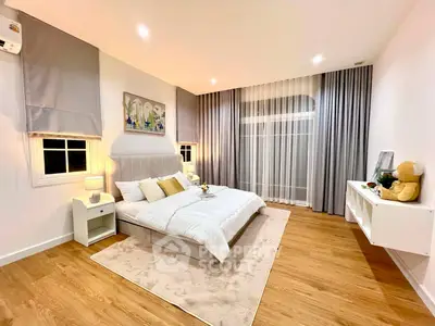 Spacious modern bedroom with elegant decor and natural light