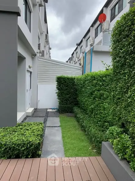 Charming townhouse exterior with lush garden and modern design