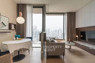 Modern living room with city view, stylish furniture, and open layout in a high-rise apartment.