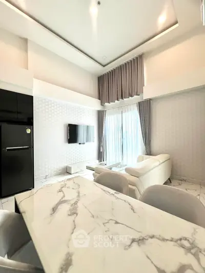 Luxurious modern living room with high ceilings and elegant marble dining table.