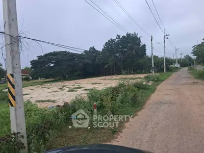 Spacious vacant land plot with lush greenery, ideal for development in a serene neighborhood.