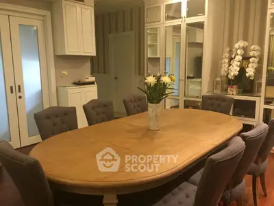 Elegant dining room with wooden table and plush chairs, perfect for family gatherings.