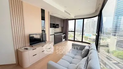 Modern living room with floor-to-ceiling windows offering stunning city views, featuring sleek furniture and built-in appliances.
