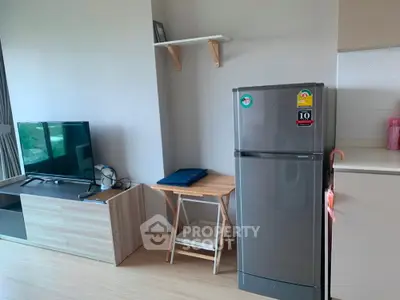 Modern living space with sleek fridge and entertainment center