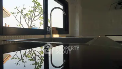 Modern kitchen with sleek countertops and large window view