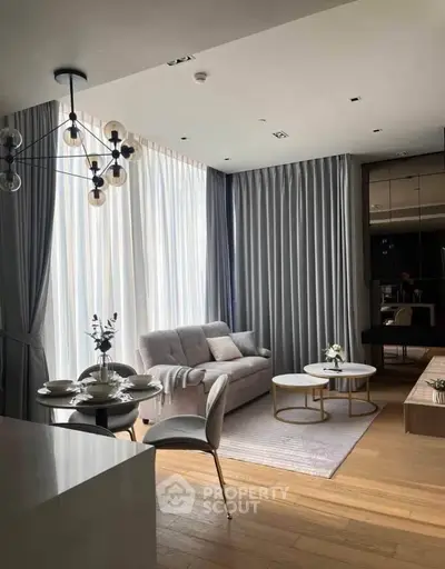 Modern living room with elegant decor, large windows, and stylish furniture in a luxurious apartment.