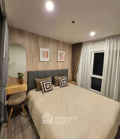 Cozy modern bedroom with stylish decor and ample natural light, perfect for relaxation and comfort.