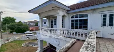 Charming two-story house with spacious balcony and classic architectural design.