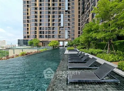Luxurious high-rise building with stunning rooftop pool and city views.