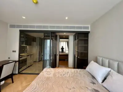 Luxurious bedroom with modern design and open kitchen layout in upscale apartment