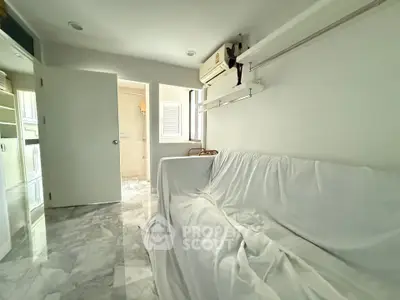 Bright and airy living room with marble flooring and air conditioning