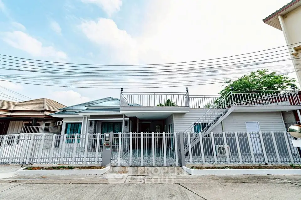 Charming single-story home with rooftop terrace and modern exterior design.