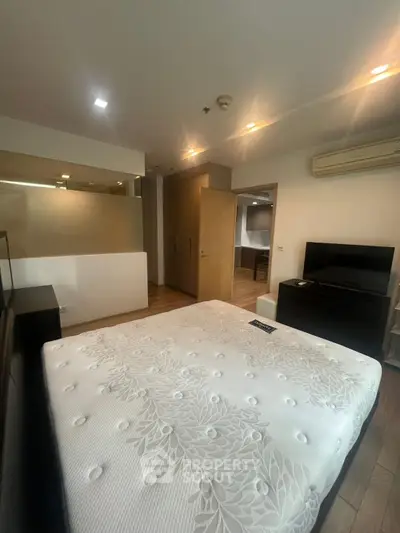 Spacious bedroom with modern furnishings and ample natural light