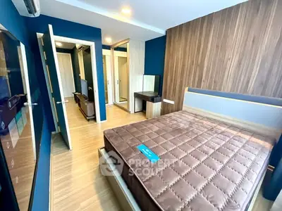 Modern bedroom with stylish wood paneling and sleek furniture in a contemporary apartment.