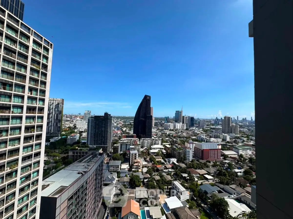 Stunning cityscape view from high-rise apartment balcony showcasing urban skyline.