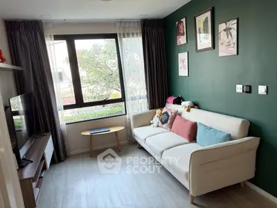 Charming living room with stylish decor and large window for natural light.