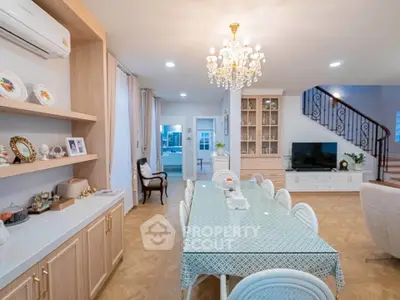 Elegant dining room with chandelier, spacious table, and stylish decor in a modern home interior.