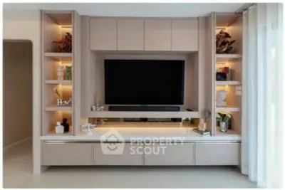 Modern living room with built-in entertainment center and elegant decor