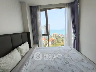 Stunning bedroom with panoramic ocean view in high-rise apartment