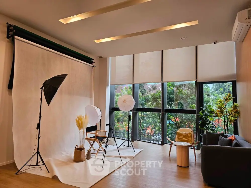 Spacious modern living room with large windows and stylish decor, perfect for photography studio setup.