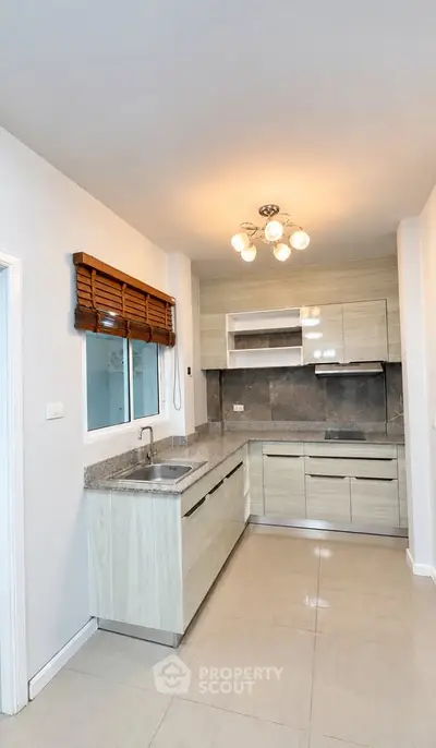 Modern kitchen with sleek cabinetry and granite countertops