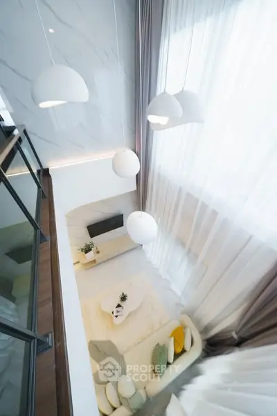 Stunning modern living room with high ceilings and elegant lighting fixtures.