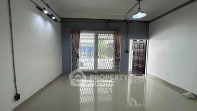 Spacious empty room with large windows and tiled flooring, ideal for customization.