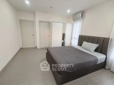 Spacious modern bedroom with sleek design and ample natural light