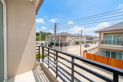 Charming balcony view in a modern residential neighborhood with clear blue skies.