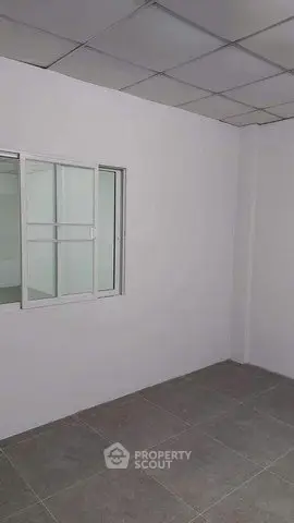 Minimalist room with tiled floor and window, ideal for customization.