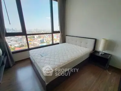 Spacious bedroom with city view and modern furnishings
