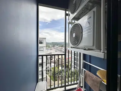Compact balcony with air conditioning units and city view in modern apartment.