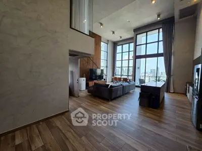 Spacious modern living room with high ceilings and city view