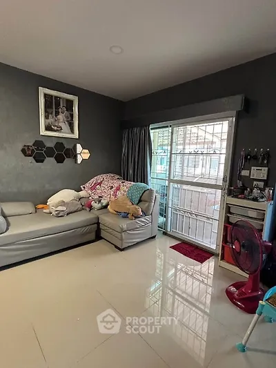 Cozy living room with modern decor and sliding glass door access to balcony.