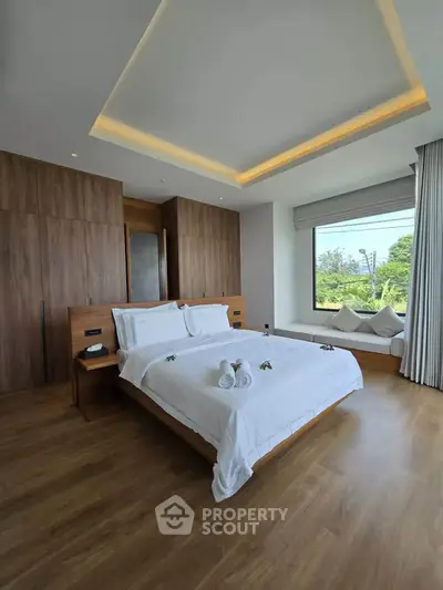 Luxurious bedroom with modern wooden accents and scenic window view